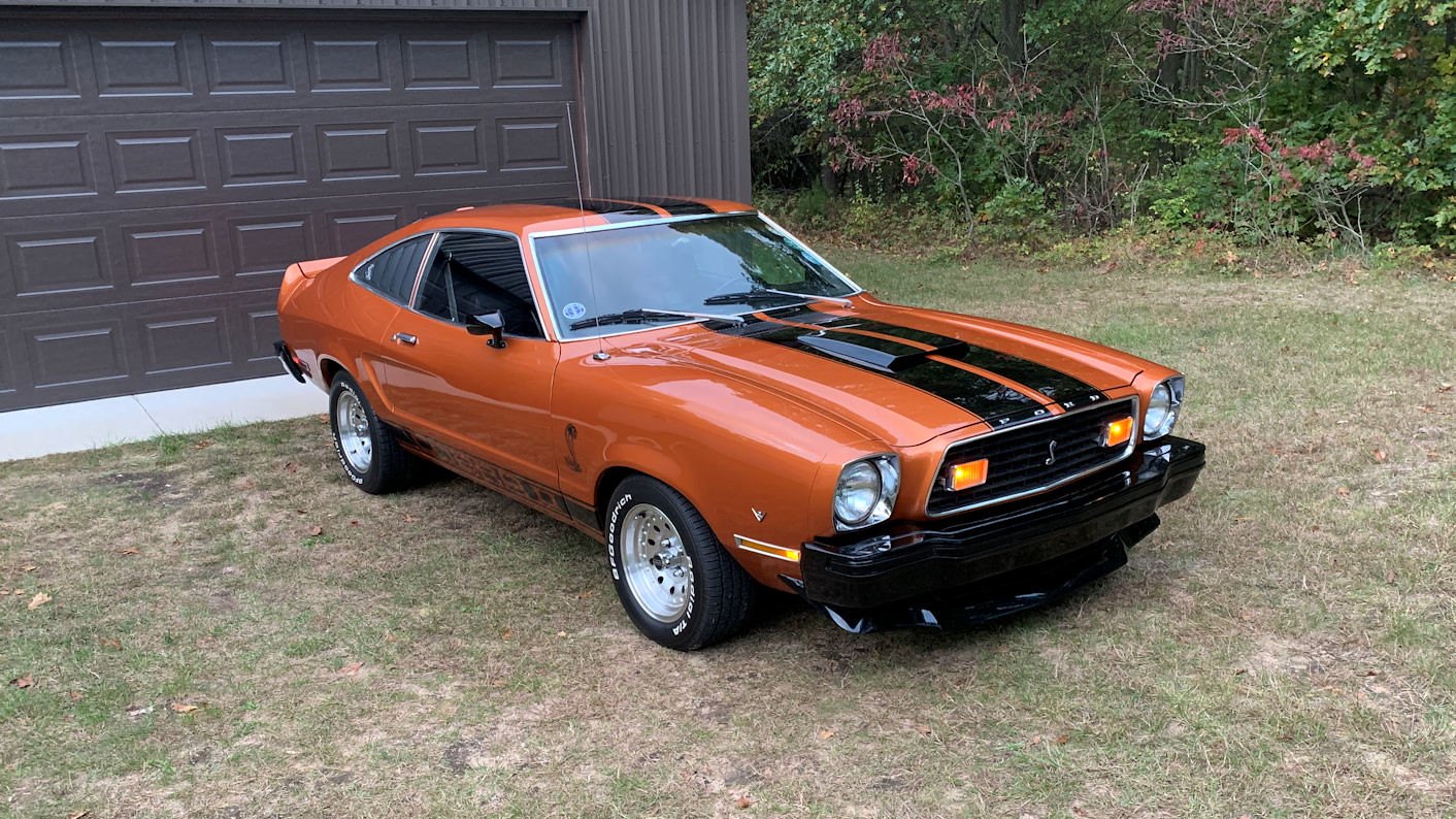 Orange 1976 Ford Mustang II Cobra II hatchback with custom tribute styling, front three-quarter view